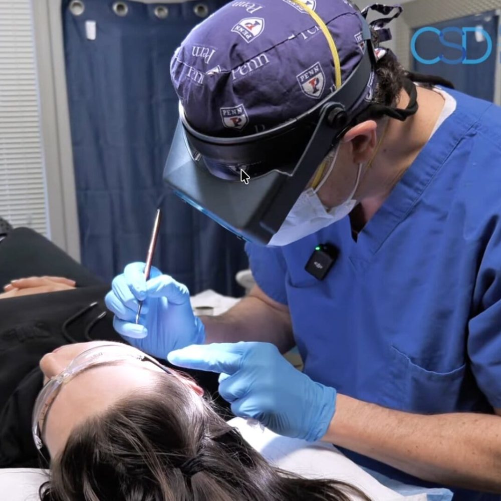 Dr. Craig Singer with a patient at his Bingham Farms dermatology practice